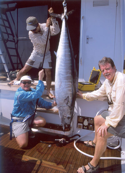 Hoisting the monster wahoo up inside the cockpit of the Foxy Lady II